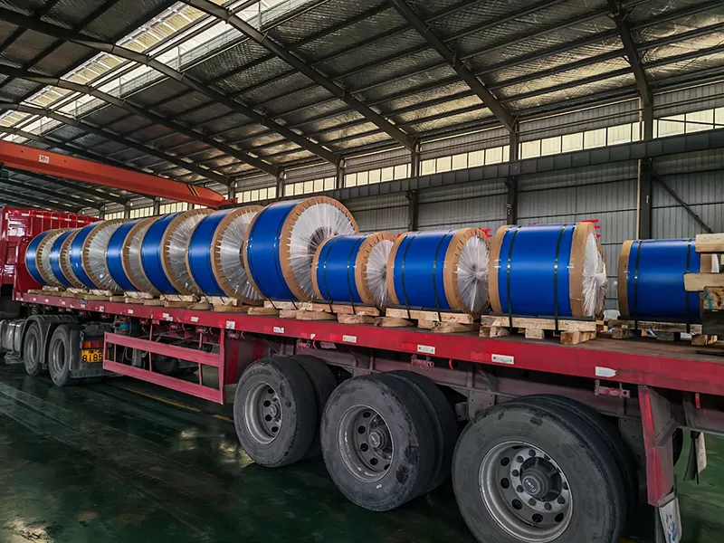 Loading aluminum strip coils for cable armoring into export truck container for global delivery